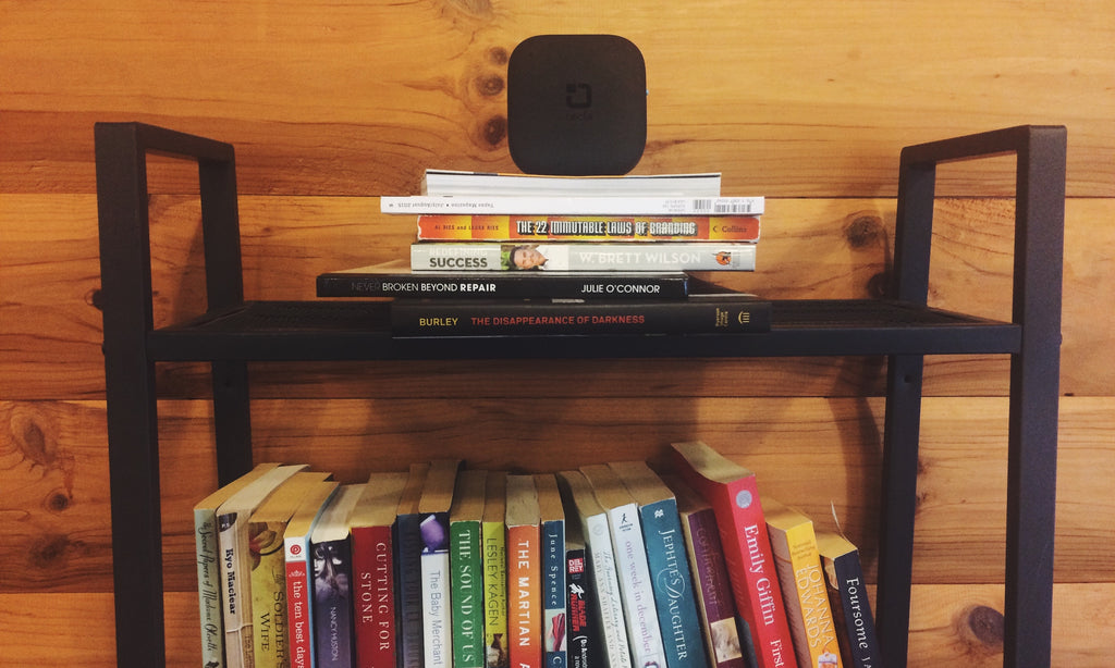 tecla-e on top of book shelf