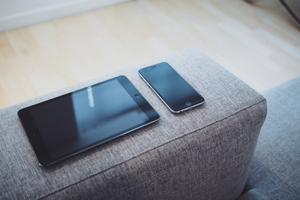 Tablet and iPhone sitting on couch